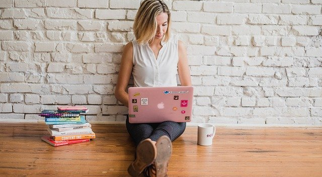 Woman on laptop with coffee